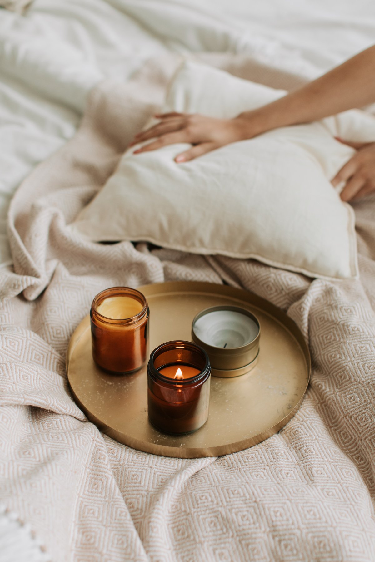 Lighted Candles on Bronze Tray on Bed